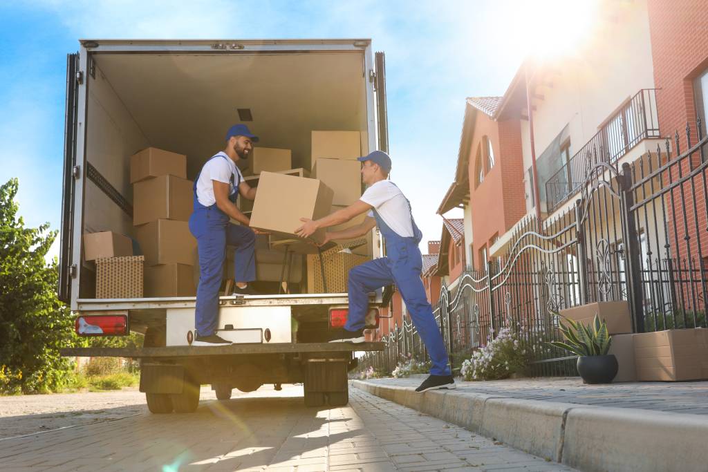 Removal men unloading boxes from removal van